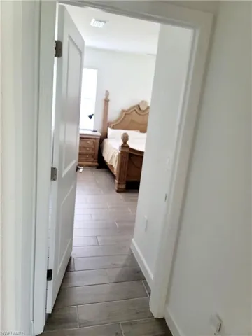 Hall featuring dark wood-type flooring