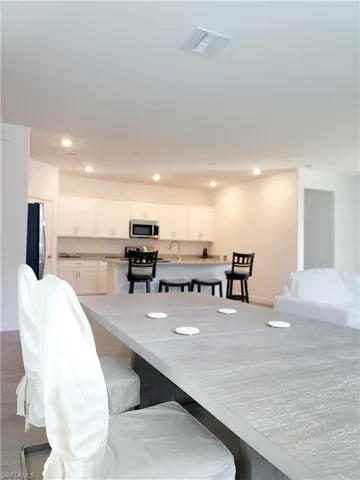 Dining space featuring recessed lighting and dark wood-style floors