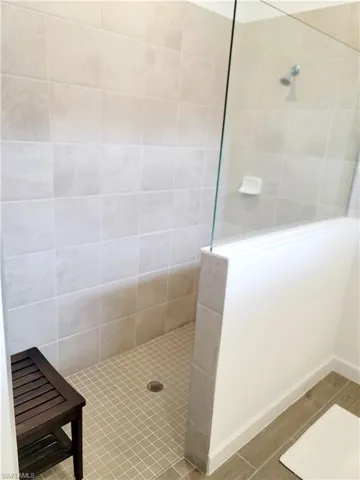 Full bathroom featuring walk in shower and wood tiled floors
