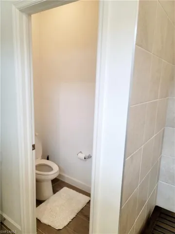 Bathroom with baseboards and dark wood-style floors