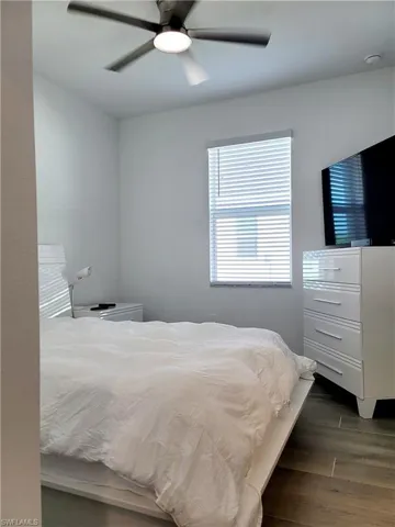 Bedroom featuring dark wood-type flooring and ceiling fan