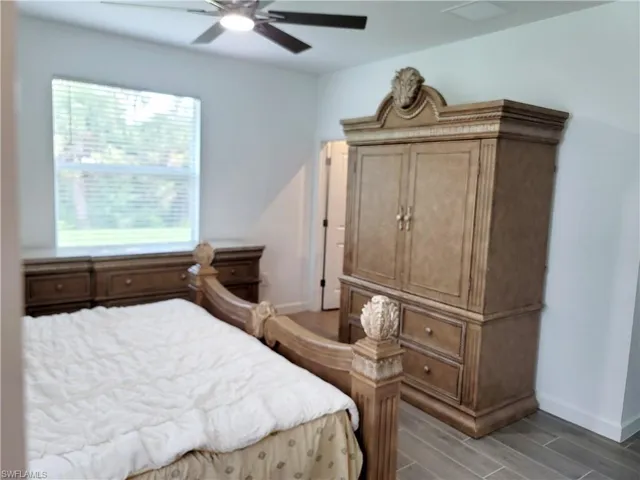Bedroom with wood finish floors and a ceiling fan