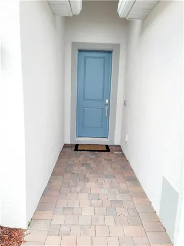 View of exterior entry featuring stucco siding