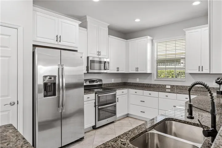 Door to left of refrigerator includes a pantry