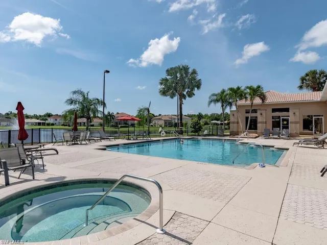 View of pool featuring a hot tub and a patio