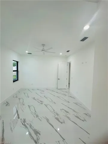 Unfurnished room featuring recessed lighting, light marble finish flooring, and ceiling fan
