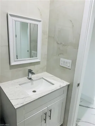 Bathroom featuring vanity and marble look tile flooring