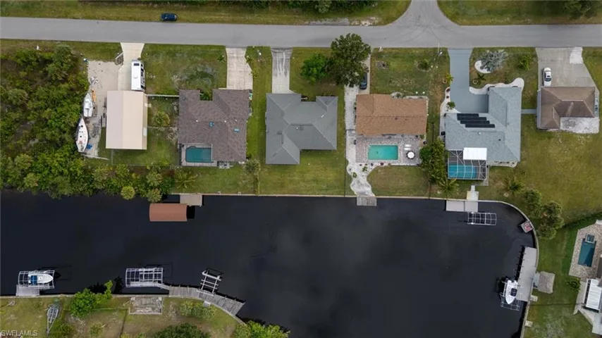 Aerial view of property's location with nearby suburban area