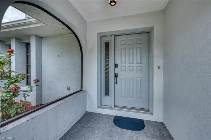 Entrance to property featuring stucco siding