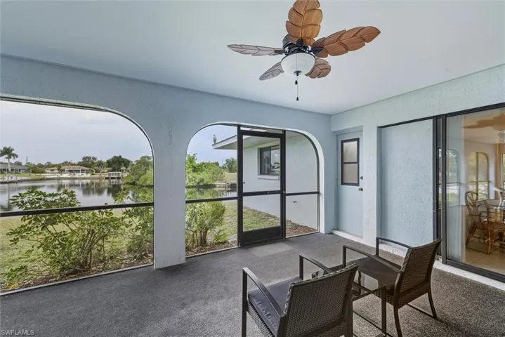 Sunroom / solarium with ceiling fan, healthy amount of natural light, and a water view
