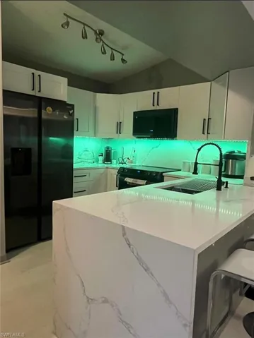 Contemporary kitchen island with waterfall edge and veined countertop