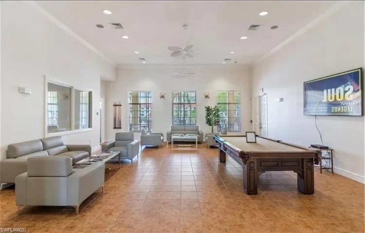 Spacious common area featuring durable tile flooring, recessed lighting, and crown molding