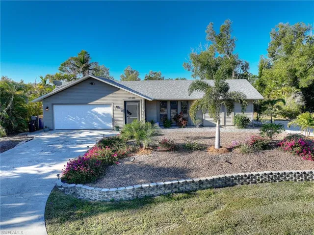 Ranch-style house driveway, an attached garage, and a shingled roof