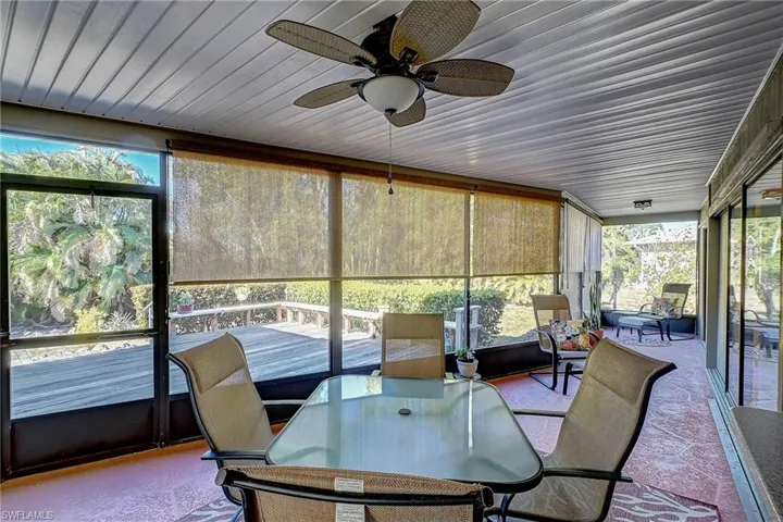 Sunroom / solarium with outdoor dining and seating area
