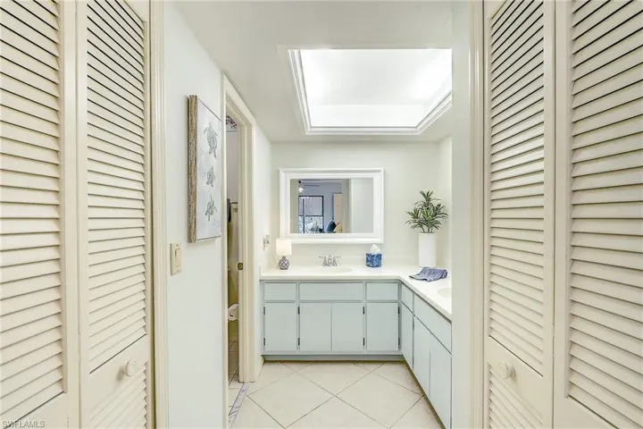Full bath with a closet, dual sinks and shower