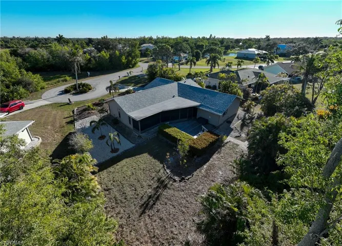 View from above of property featuring a tree filled landscape
