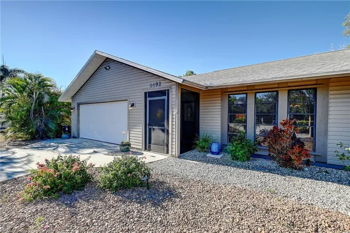 Ranch-style house featuring concrete driveway and a garage