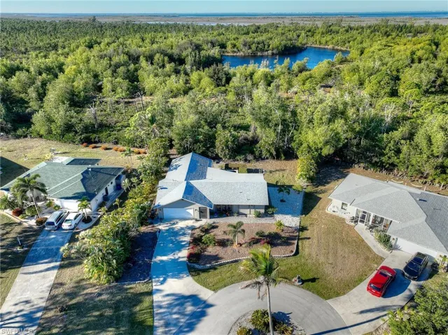 Bird's eye view of a nearby body of water and a heavily wooded area
