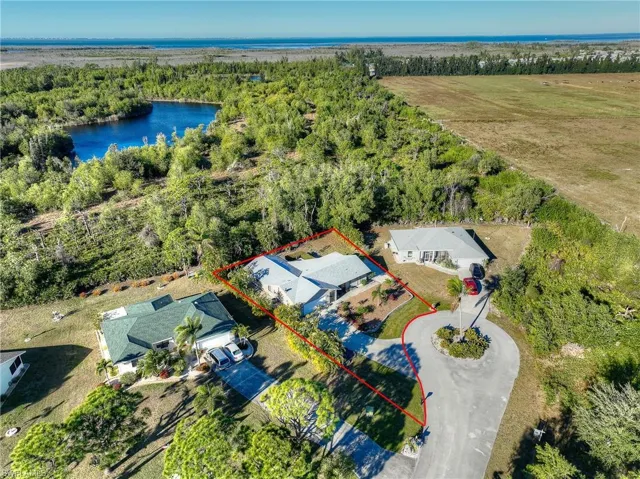 Aerial view of property's location featuring , lake and property boundaries highlighted