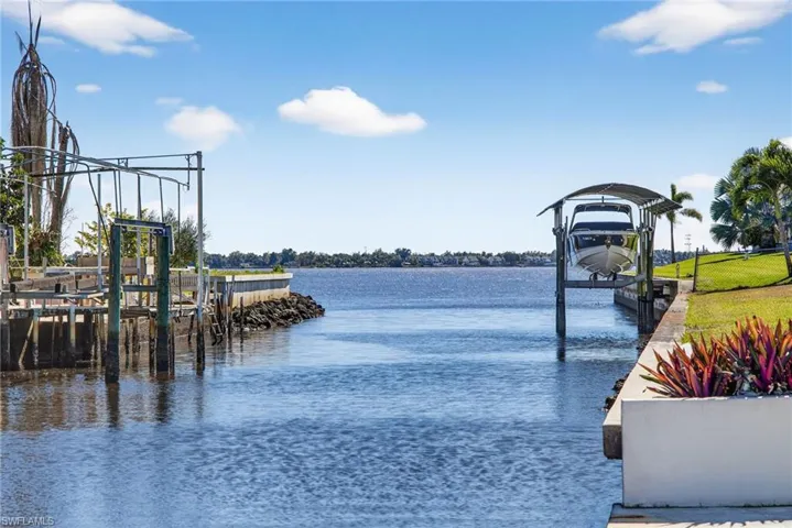 Dock featuring boat lift and a water view