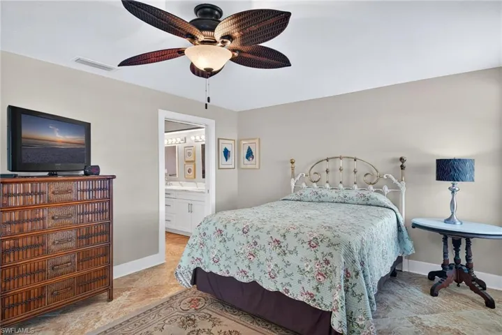 Bedroom with ceiling fan and ensuite bathroom