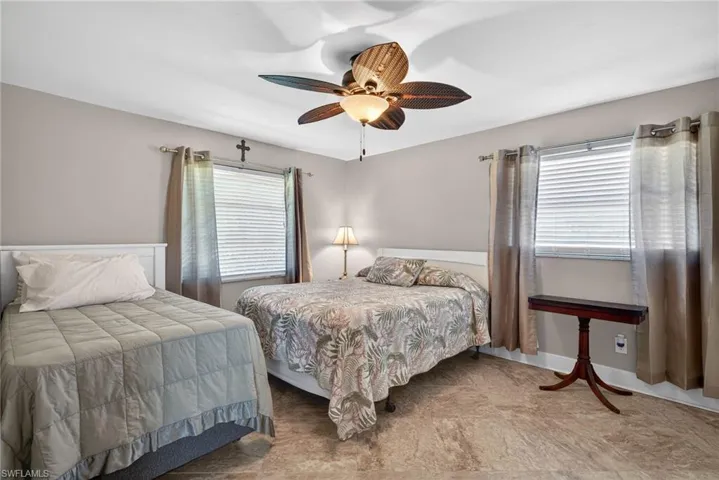 Bedroom with a ceiling fan and baseboards