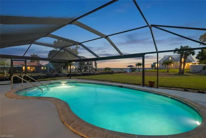 Outdoor pool with a yard, a lanai, a sunroom, and a patio