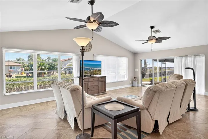 Living area featuring high vaulted ceiling and ceiling fan