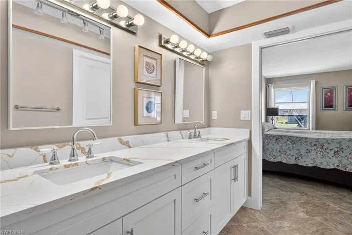 Bathroom featuring connected bathroom and double vanity