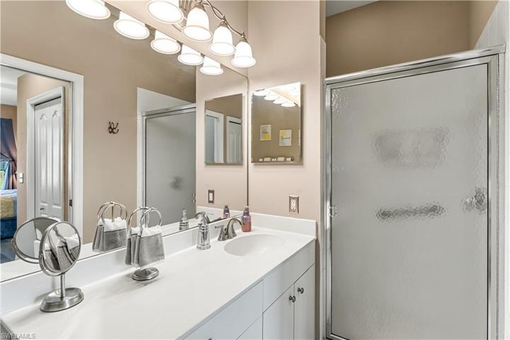 Ensuite master bath offers a walk in shower and single vanity.