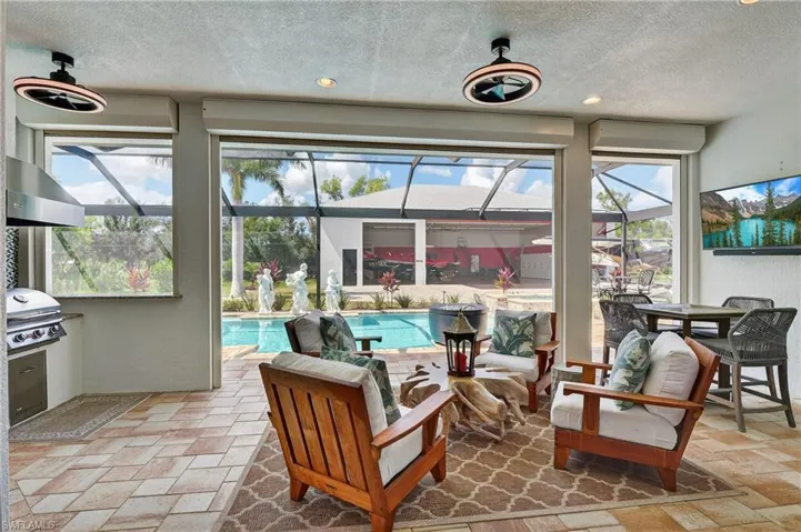 Sunroom / solarium with a patio area and a swimming pool