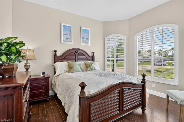 Bedroom featuring wood-style tile flooring and baseboards