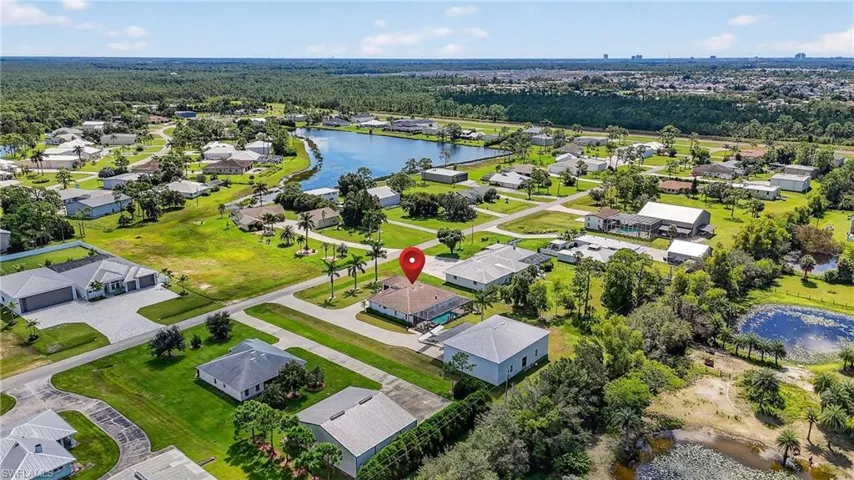 Aerial view of residential area featuring a nearby lake