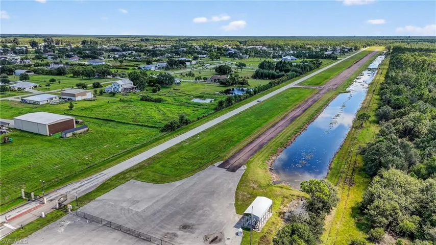 Paved Runway and grass strip 09E/27W  Pine Shadows Airpark, 94FL