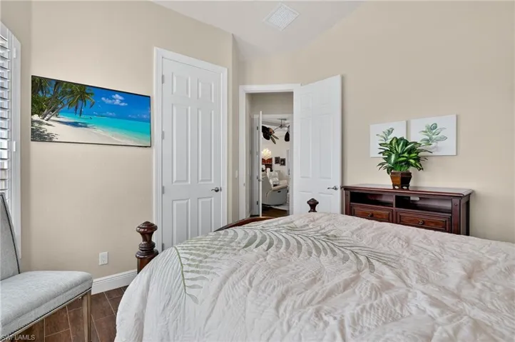 Bedroom with wood-style tile flooring and baseboards