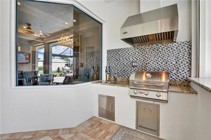 View of patio / featuring an outdoor kitchen, with grill and a sink