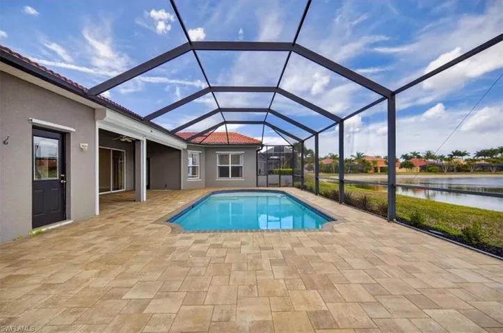 Outdoor pool with a lanai, patio area & water view