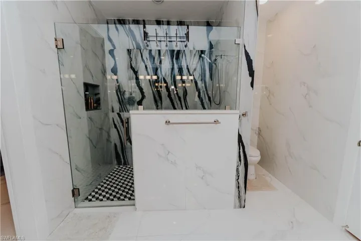 Bathroom with toilet and a shower with door