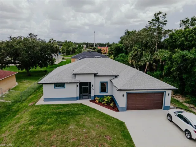 View of front of house with a garage and a front yard