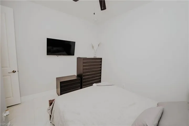 Mother-in-law suit Bedroom featuring ceiling fan and light tile patterned floors