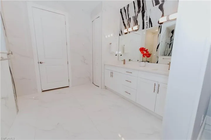 Bathroom featuring vanity and Walk in closet.