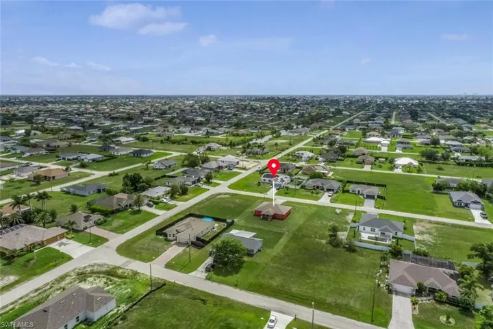 Aerial view of property's location with nearby suburban area