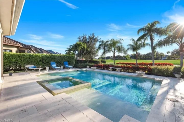 View of swimming pool with a patio area and a pool with connected hot tub