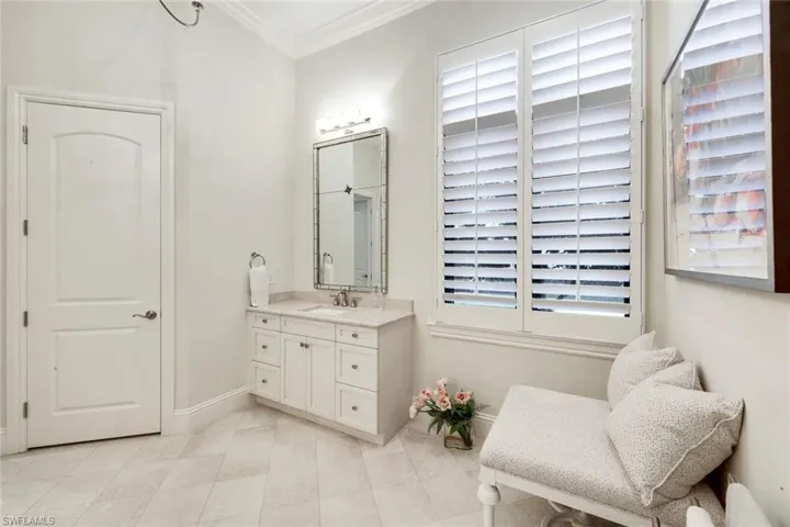 Bedroom with access to exterior, plantation shutter, french doors, crown molding, carpet, and a tray ceiling