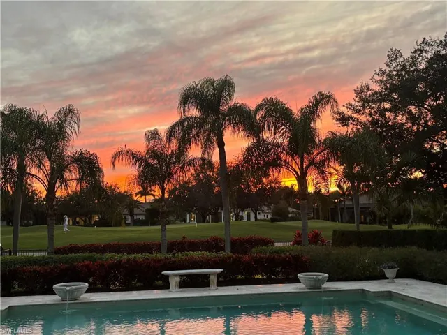 View of pool featuring a fenced backyard, a patio, a pool with connected hot tub, and an outdoor fire pit