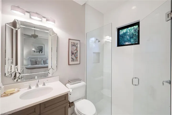 Full bath with tub shower / bath combination with curtain, vanity, and connected WIC