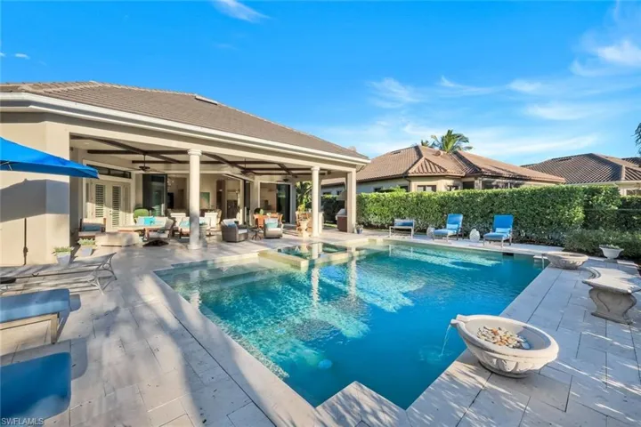 View of swimming pool with a patio and a pool with connected hot tub