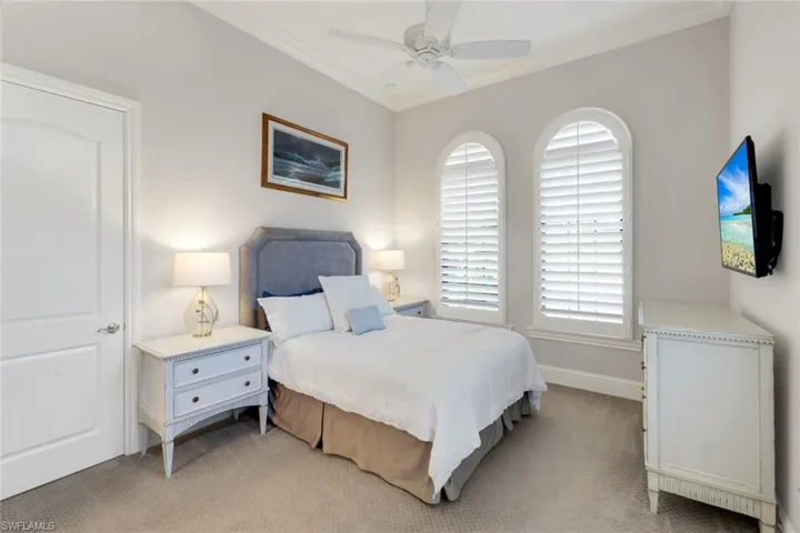 3nd Bedroom with Queen Bed light colored carpet, ceiling fan, and crown molding