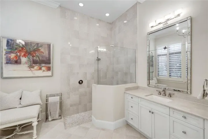 King Bedroom featuring access to outside, carpet flooring, a tray ceiling, a chandelier, and crown molding