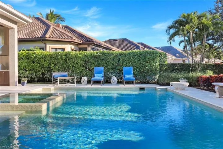 View of pool with a patio and an outdoor fire pit